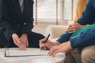 couple signing an insurance form