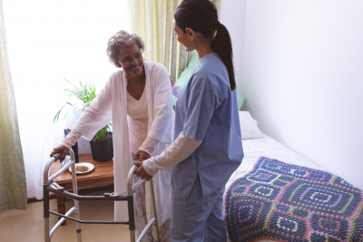 nurse assisting a senior woman