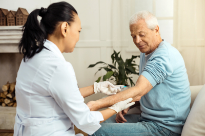 nurse injecting a senior man